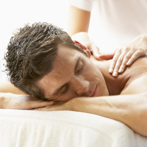 Young Man Enjoying Massage At Spa